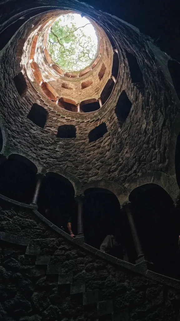 de trappen van de initiation well brengen je naar een heel andere plek in het park van quinta da regaleira